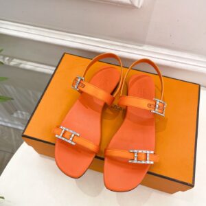 Hermès orange leather slippers with silver H buckle