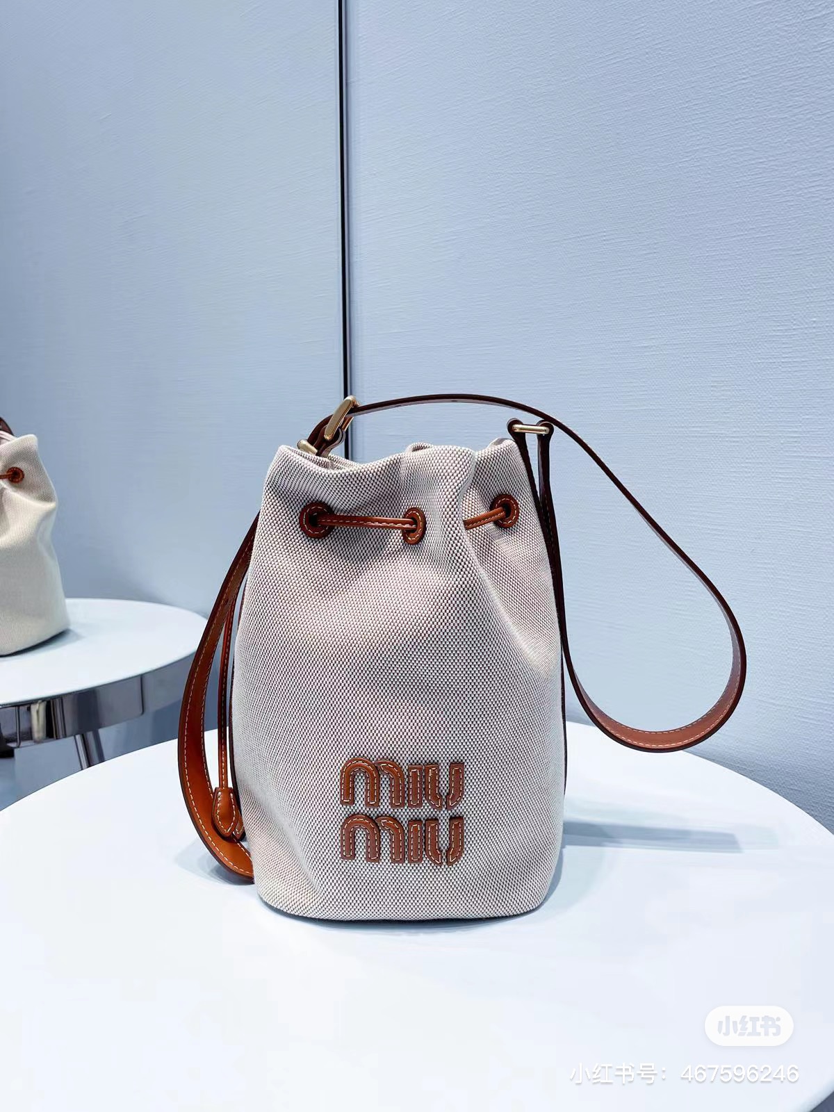 Miu Miu Logo leather-trimmed bucket bag in beige – Miu Miu |